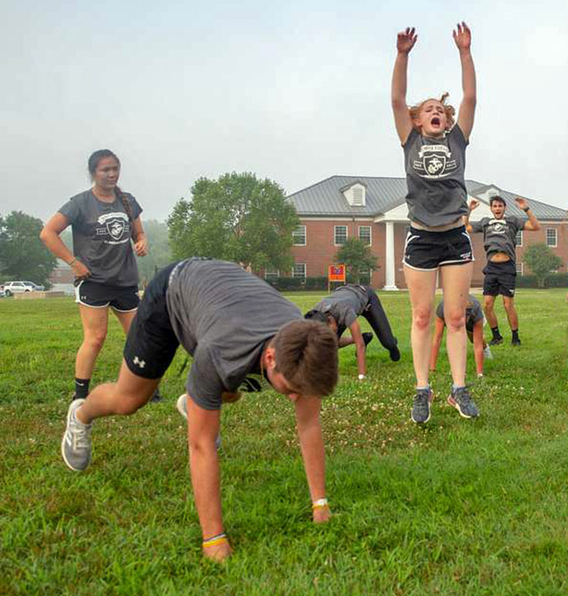 Athletes performing burpee exercise during fitness test