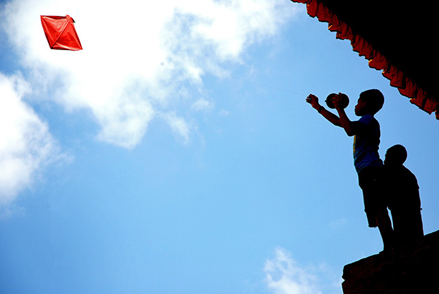 kids in Nepal flying a paper kite