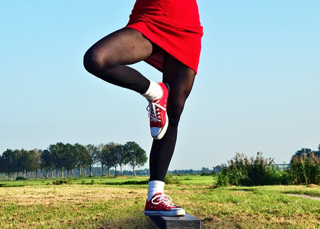 Athlete performing flamingo balance test on beam